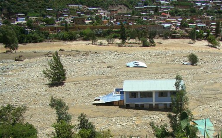 Homes are submerged after a landslide in Porvenir, Peru, on Friday.